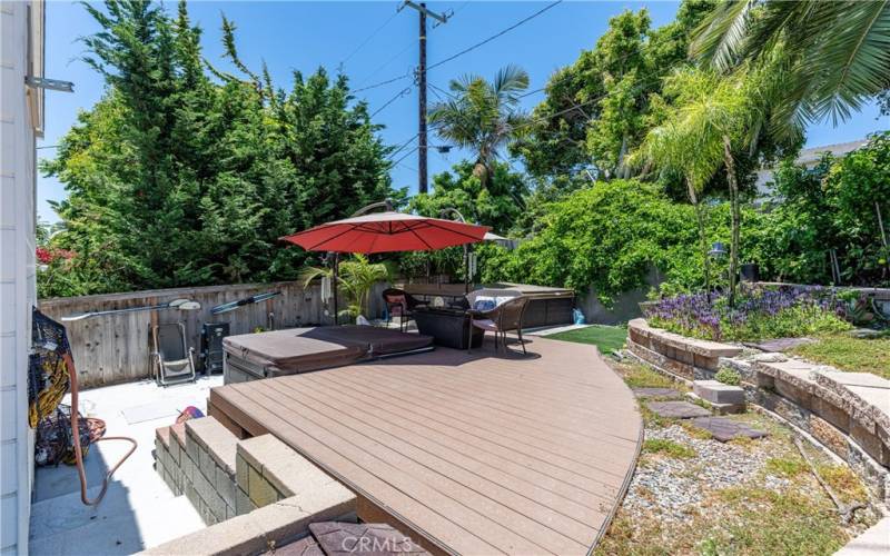 A raised patio, shady relaxation area, and mature landscaping make the backyard the perfect place to relax!