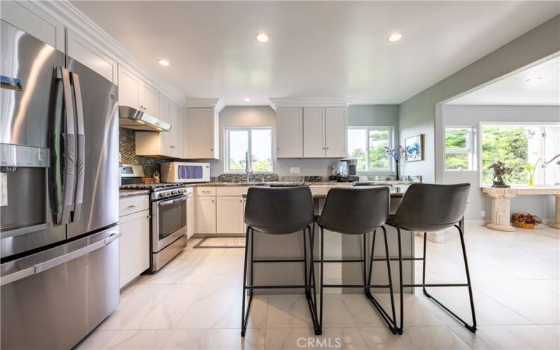 The gourmet kitchen has gorgeous stainless steel appliances, ample storage, granite counters, and a functional center island!