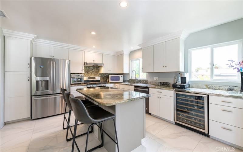 The sunny kitchen is bursting with natural light! A lovely ocean breeze keeps you cool at the sink. Ample counter space and storage plus state-of-the-art stainless steel appliances!