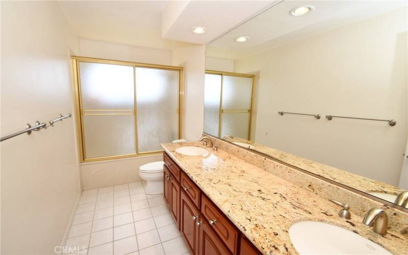 Upstairs bathroom with double sinks and shower.