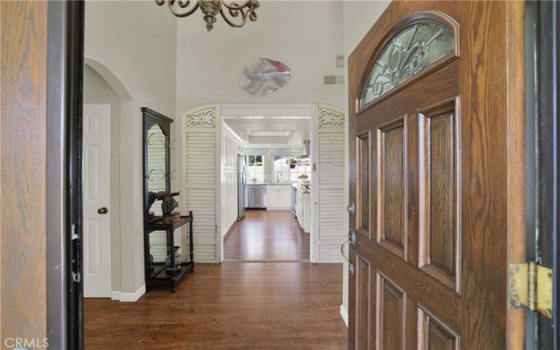 Beautiful wood floors welcome you to high ceilings and expansive views through the kitchen and to backyard beyond.