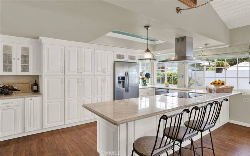 Just can't say enough about this kitchen!  Large breakfast bar/island looks onto all that storage and beautiful windows beckon to the backyard beyond.