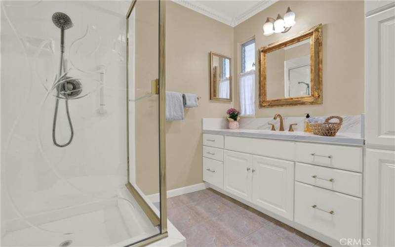 Secondary bathroom with walk-in shower.