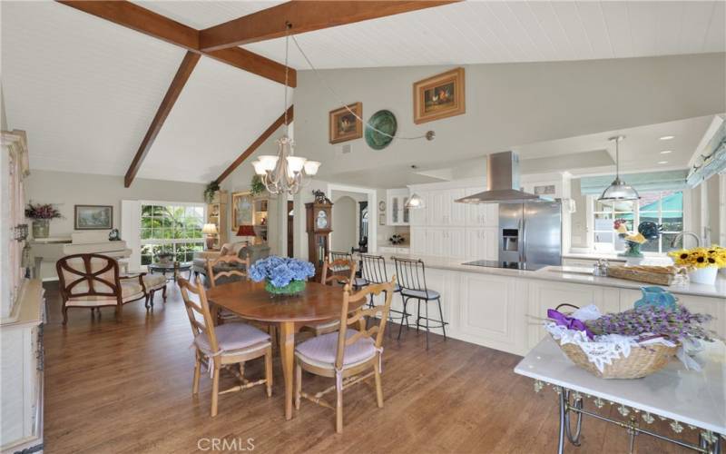 Beautiful beamed ceilings with tongue & groove wood looking from the dining area towards the living room.