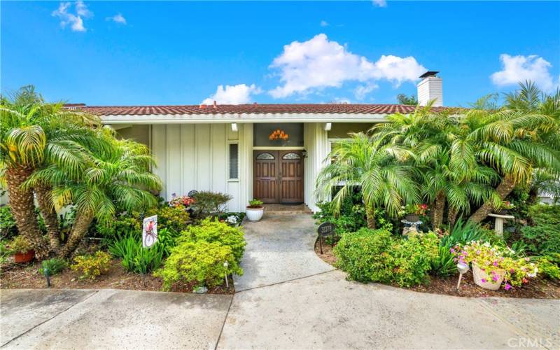 Lush landscaping surrounds the property