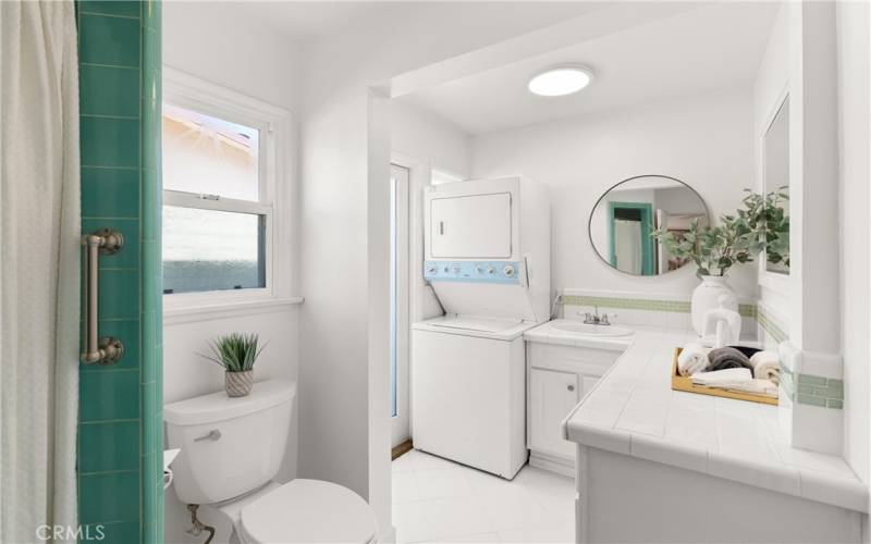 Immaculate primary suite bathroom with washer/dryer