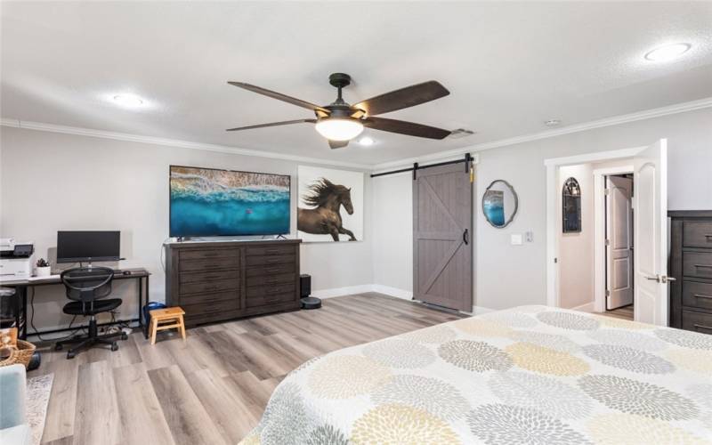 Primary Bedroom with Fan and recessed ceiling