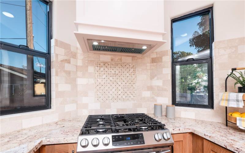 Stainless steel appliances with custom hood