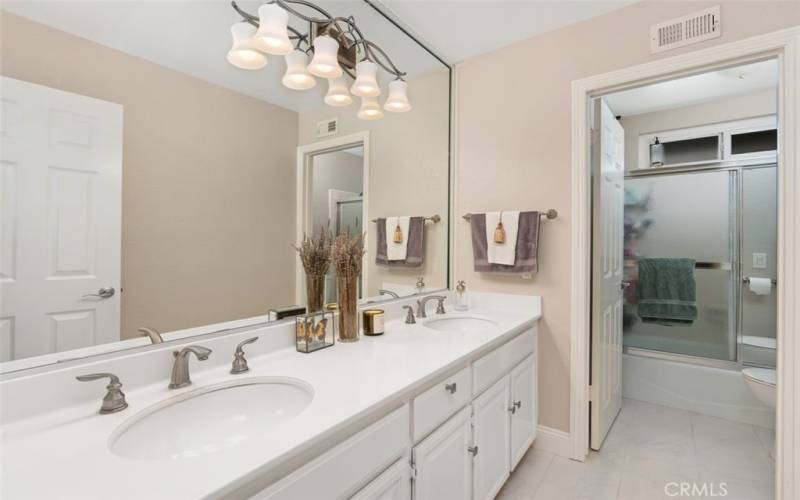 A large bathroom off the upstairs hall has dual sinks for added convenience.