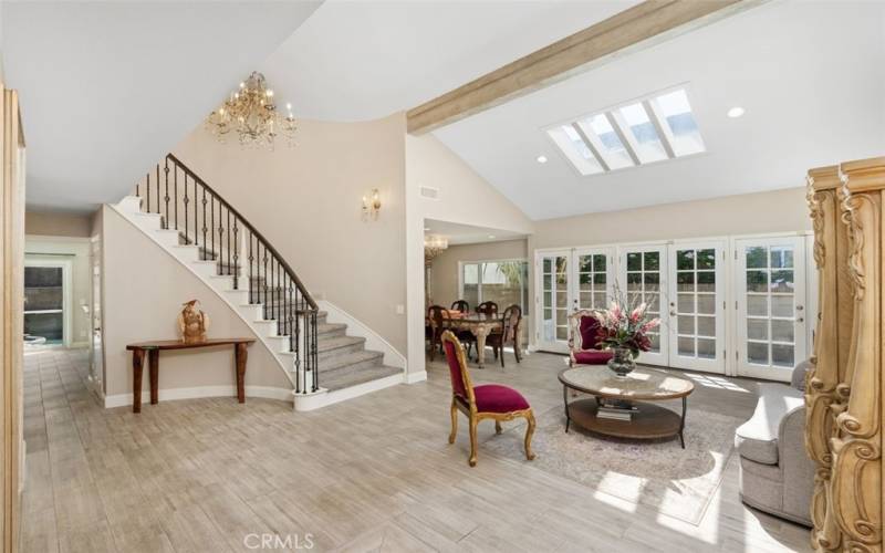 Skylights and multiple French doors illuminate the space.