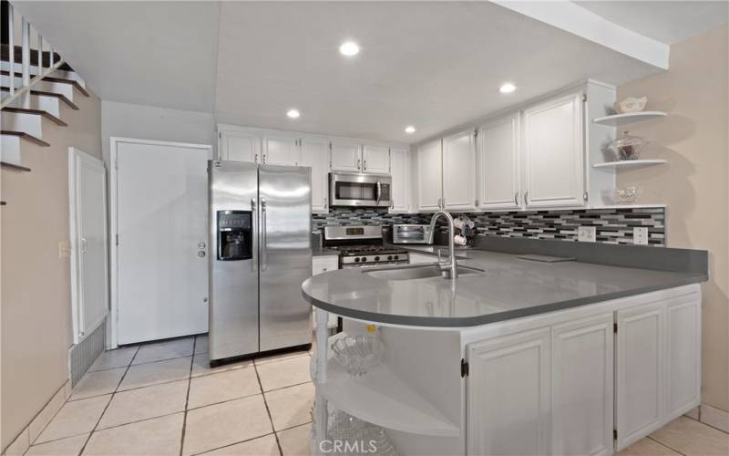 kitchen island is extra wide with cabintets that open on both sides