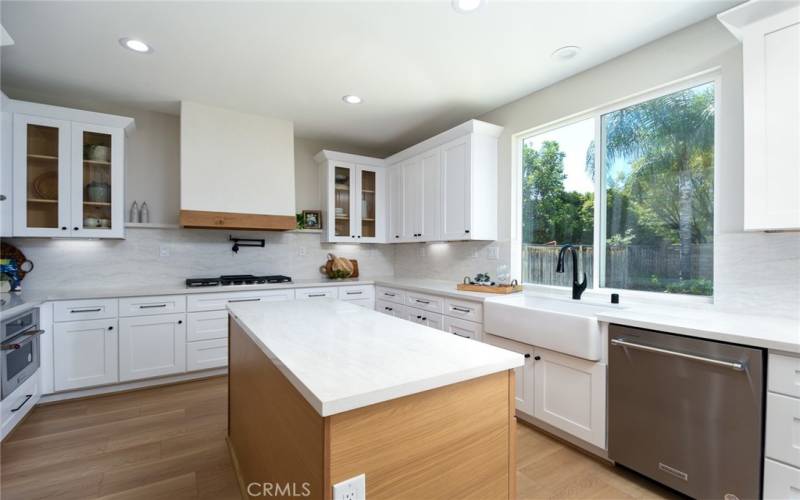 Newly remodeled kitchen with new white, shaker cabinetry and white oak accents.