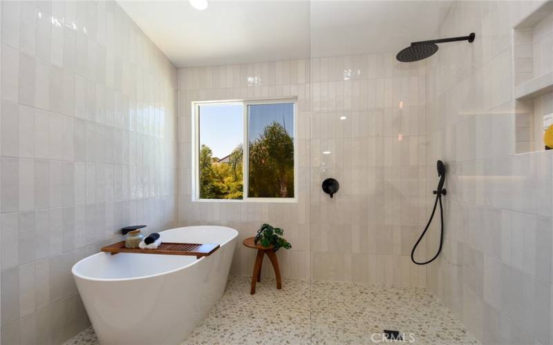 Modern primary bathroom with open wet room layout.