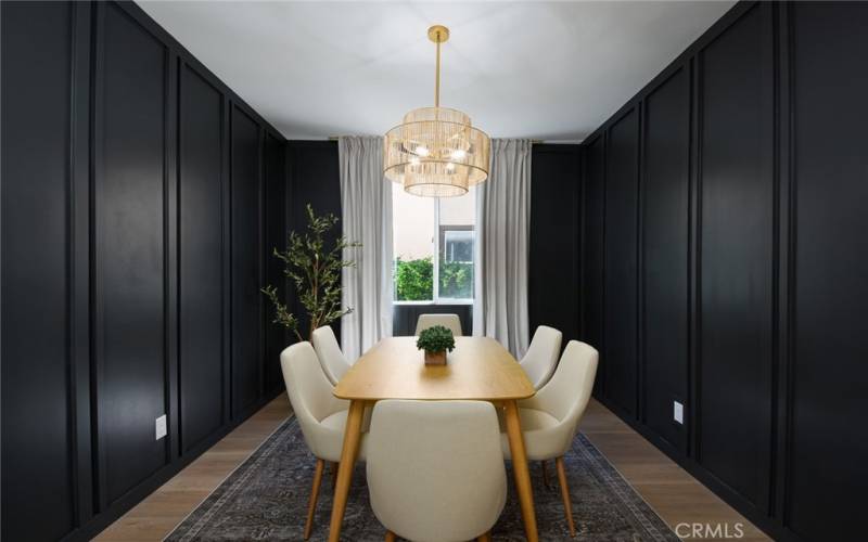 The dining room is striking painted in a deep charcoal color to accent the custom molding accent walls!