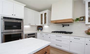 Newly remodeled kitchen with upgraded stainless steel appliances including a double oven, 36