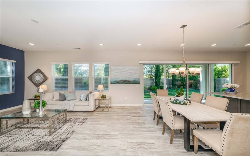 Large folding doors lead out to backyard covered patio