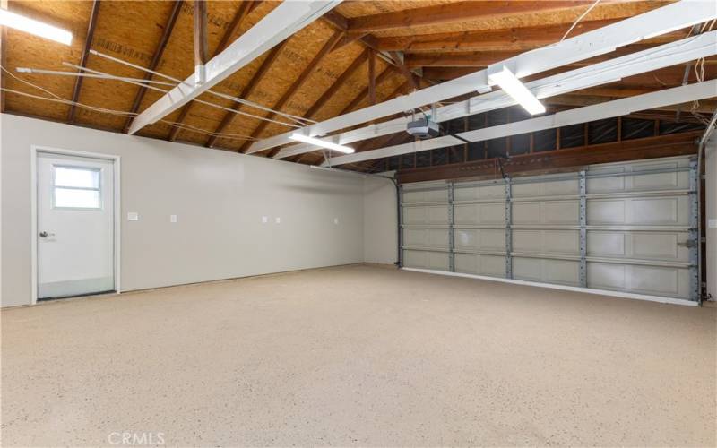 Sheetrocked and painted garage with epoxy floor coating and new garage door opener.