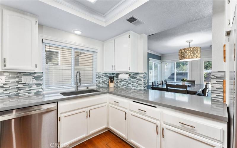 Kitchen view overlooking dining area through pass through