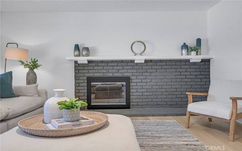 Newly updated gas starter brick fireplace and new built-in screen