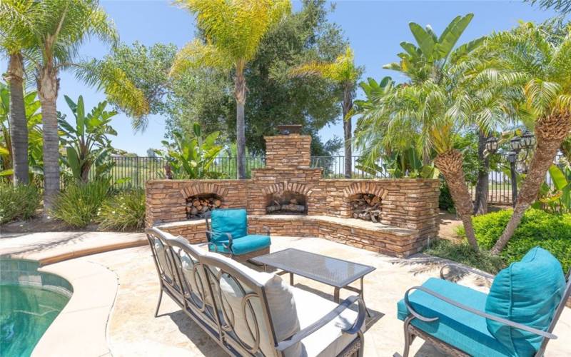 Inviting outdoor fireplace area with cozy seating, perfect for relaxation and entertaining.