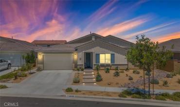 This beautiful single-story home features a modern, drought-resistant landscape and a welcoming front porch.