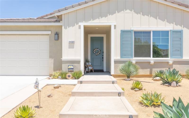 The inviting entry of this home features a charming front porch creating a warm and welcoming atmosphere.