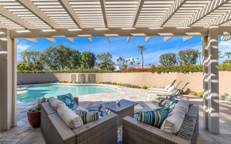 covered seating area by private pool