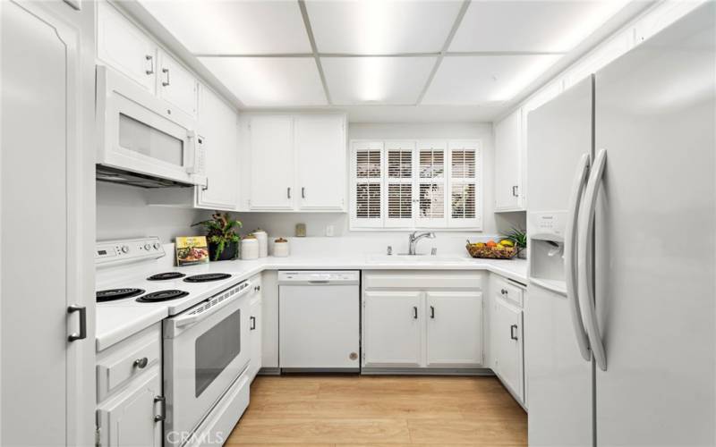 The re-styled, freshly painted kitchen is charming and bright, boasting the necessary appliances.