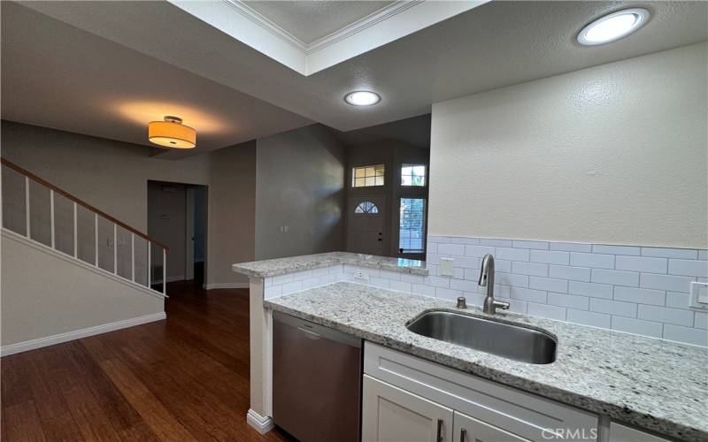 Gourmet Kitchen with SS appliances, quartz counters, and white cabinetry!