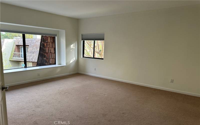 Primary bedroom with high ceilings