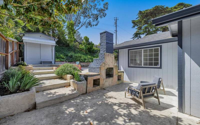 Built-in backyard fireplace could also be used for BBQ.