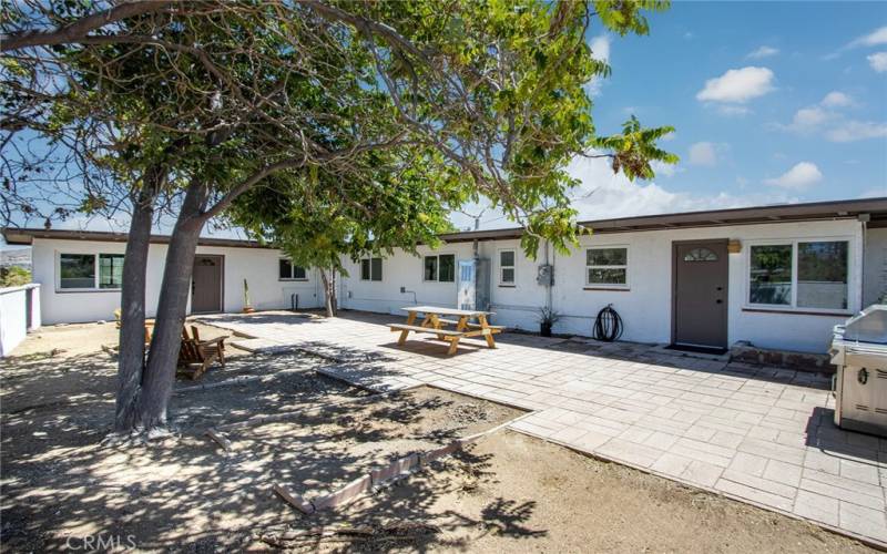 Another view of rear property with access to main house and private entrance to guest house on the left