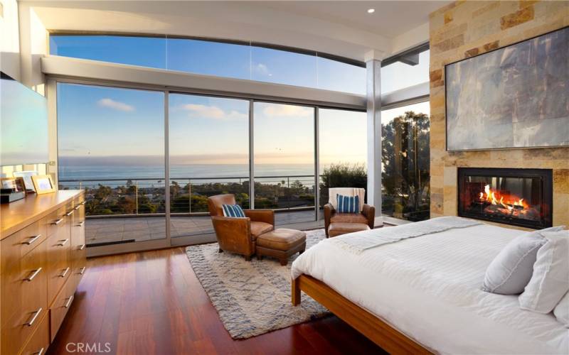 Primary Bedroom (king bed), upper level, floor to ceiling windows.