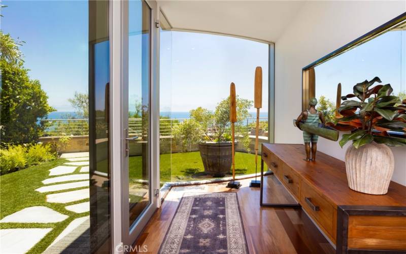 Inviting Entry, glass front door, abundant light, floor to ceiling glass.