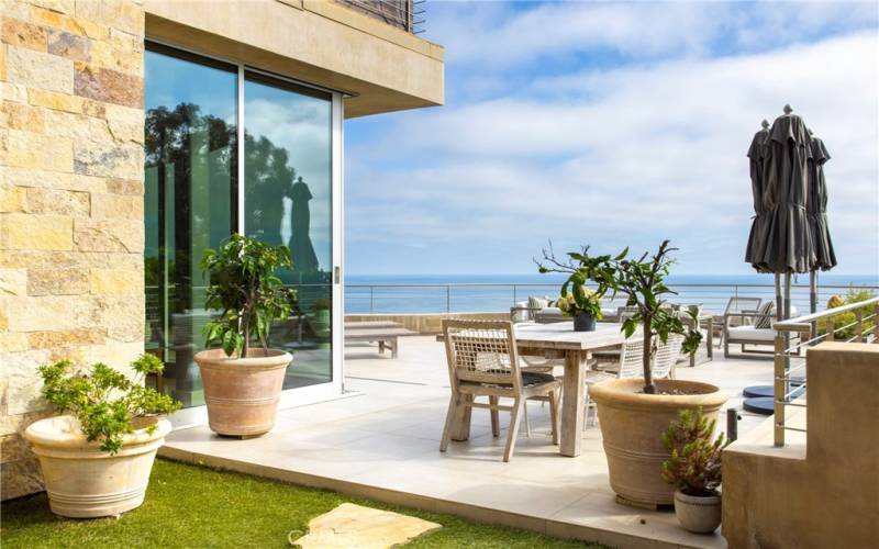 Protected area of view deck facing sliding doors to kitchen.