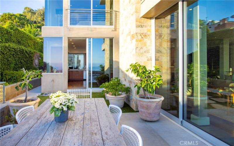 Protected area of view deck facing sliding doors to kitchen.