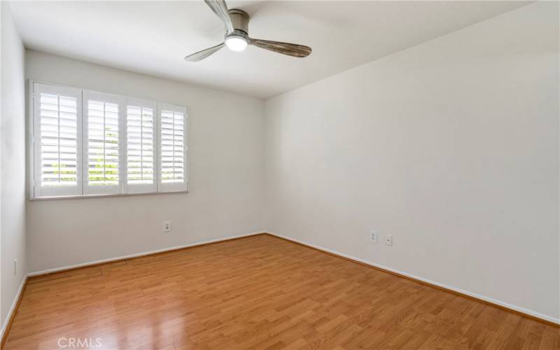 Upstairs bedroom 2.  Plantation shutters & ceiling fan