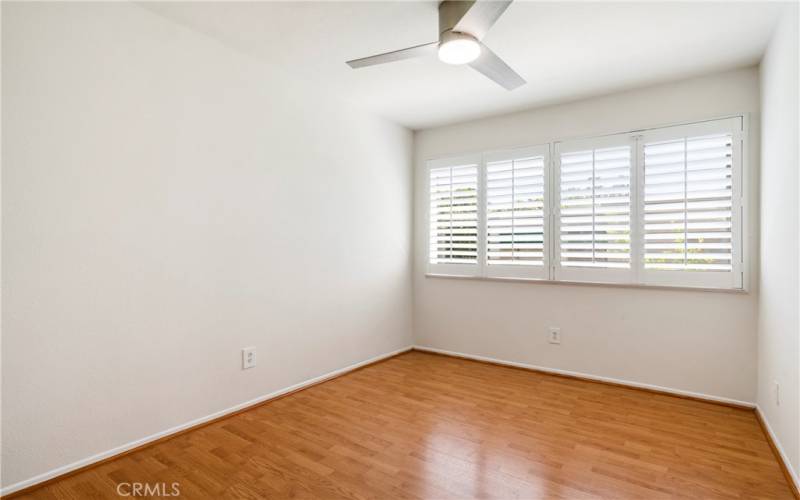 Upstairs bedroom 1.  Plantation shutters & ceiling fan