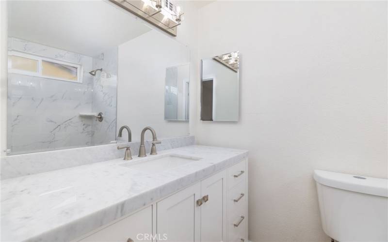 Completely remodeled master with new; vanity, mirror, medicine cabinet, lighting & hardware.  Marble countertop with new toilet.