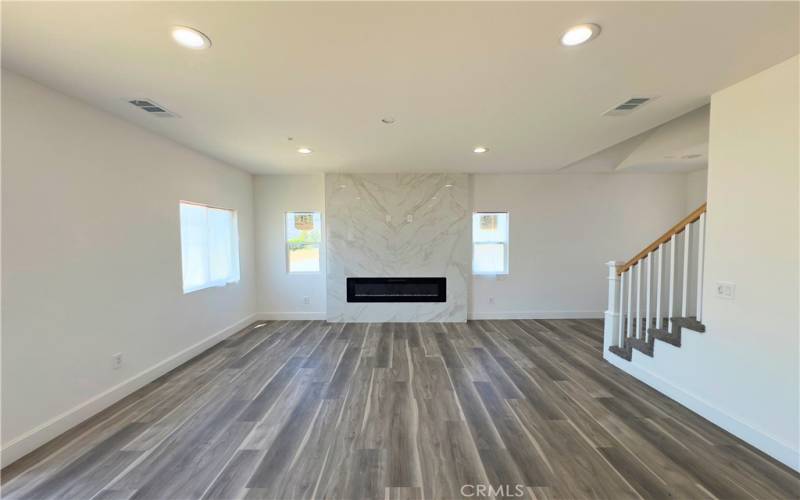 Super bright living room with built in fireplace.