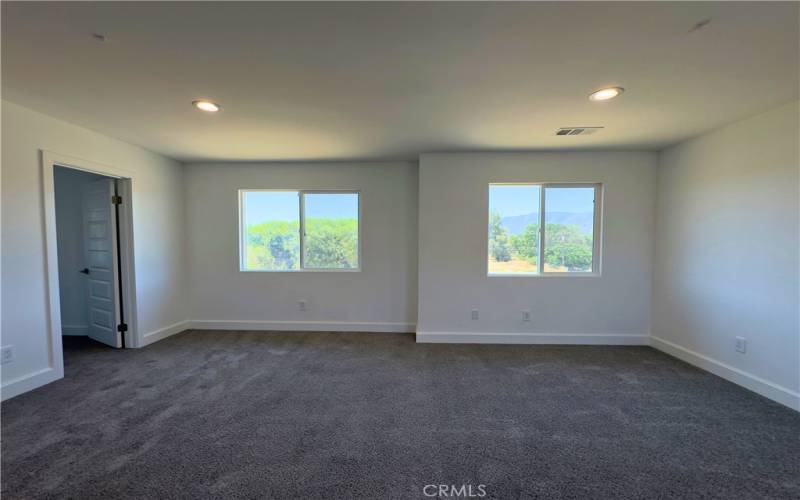 Spacious master bedroom with partial view of the lake.