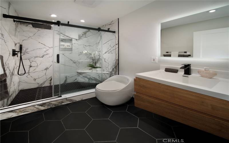 Beautiful and chic guest bathroom with custom tile flooring, fixtures and porcelain shower