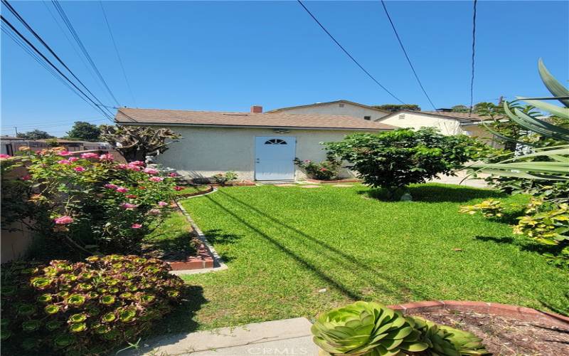 BACKYARD WITH GARAGE SIDE DOOR ENTRANCE