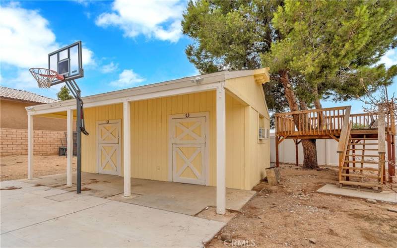 2 stall horse barn with tree house to the right.