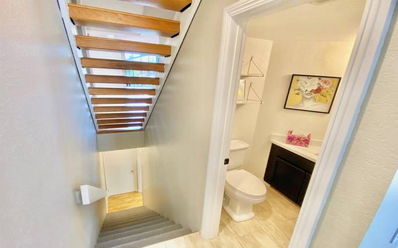 Half bath located on main level off of Kitchen. Stairwell downstairs leads to the 2-Car Garage