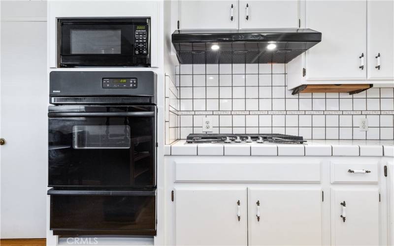 Double wall oven, microwave and gas stove top.