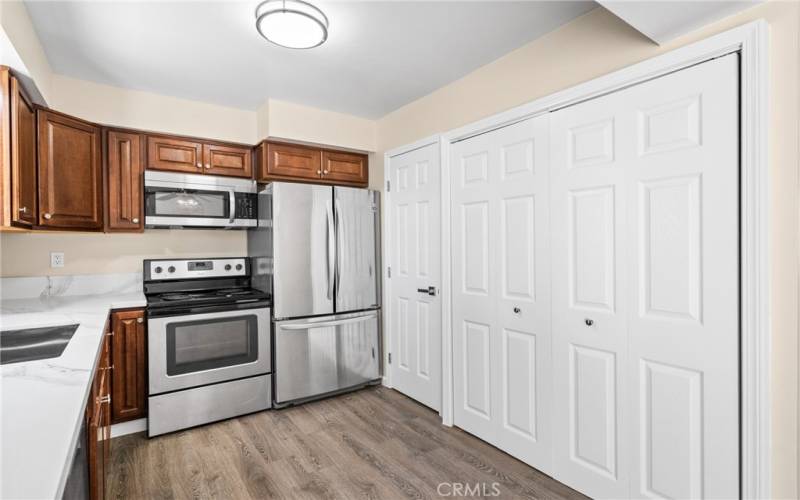 Imagine preparing meals with your stainless-steel appliances, dark wood shaker style cabinetry and a pantry