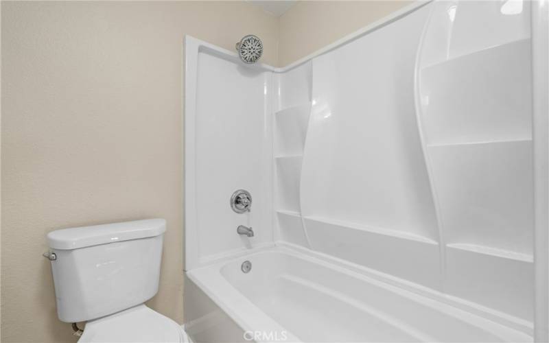 Refreshed shower/tub with plenty of built in shelving!