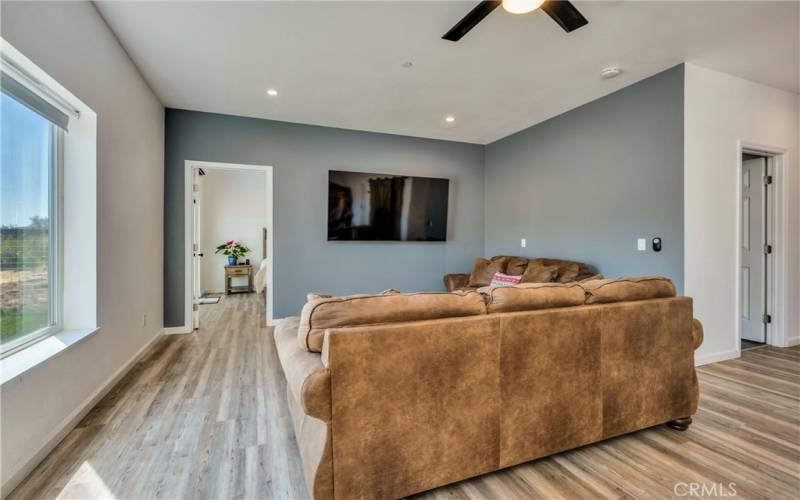 Living room and door leads to primary bedroom