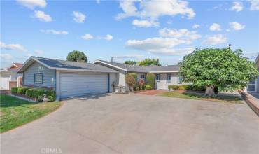 Handsome curb appeal with a large concrete driveway, attached two car garage, and a composition roof.